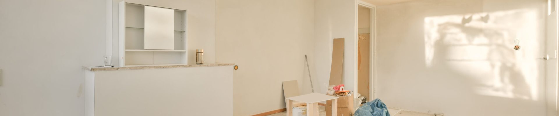 A spacious room under renovation in bright colors with building materials